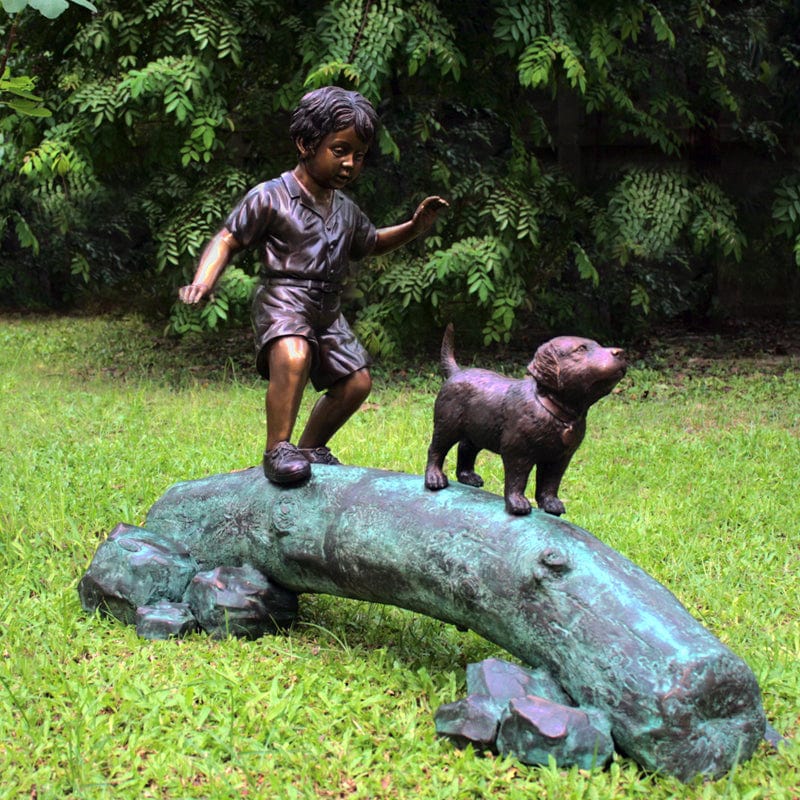 Boy Following Dog Across Log Brass Baron Outdoor Statue - Outdoor Art Pros